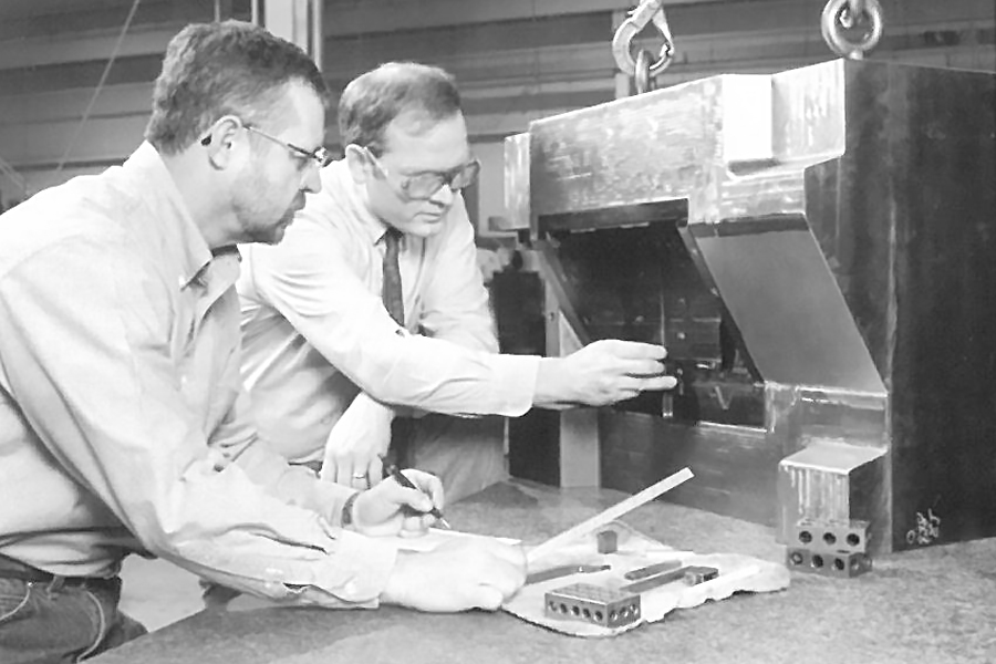 Commercial Tool Group image of the company owner and a mold tech examining a plastic injection mold