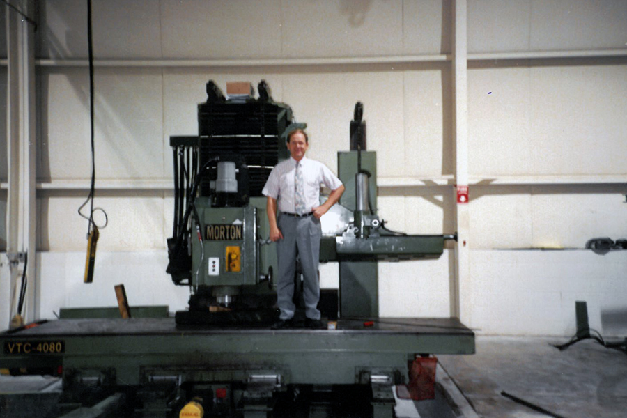 Commercial Tool Group image of the company owner standing on a Morton Milling Machine