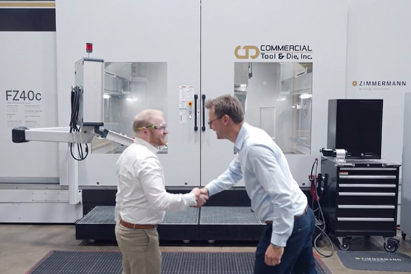 Commercial Tool Group CTG image of Zimmerman and senior leadership shaking hands in from of a CTG branded Zimmerman Milling Machine