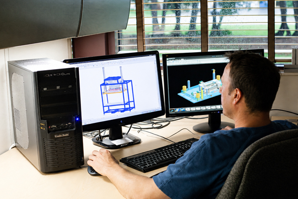 Commercial Tool Group image of a CTG CAD specialist sitting in an office working on a fixture design using a PC
