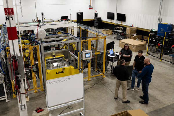 Commercial Tool Group image of team members discussing an automation cell test